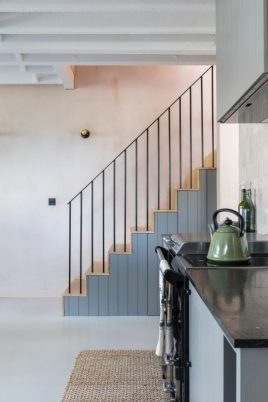 Kitchen and stairs featuring polished concrete