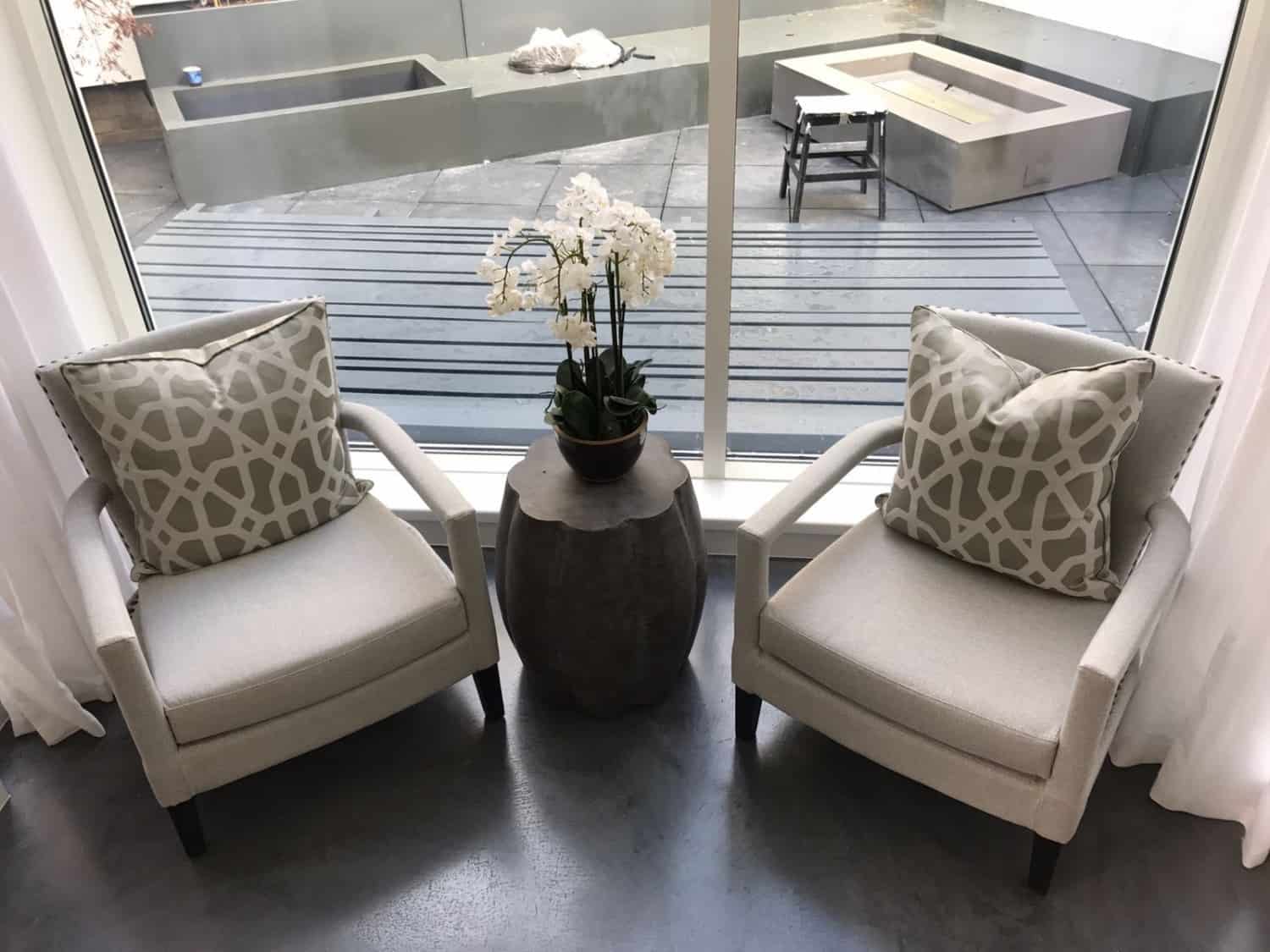 Dark polished concrete floor with two chairs