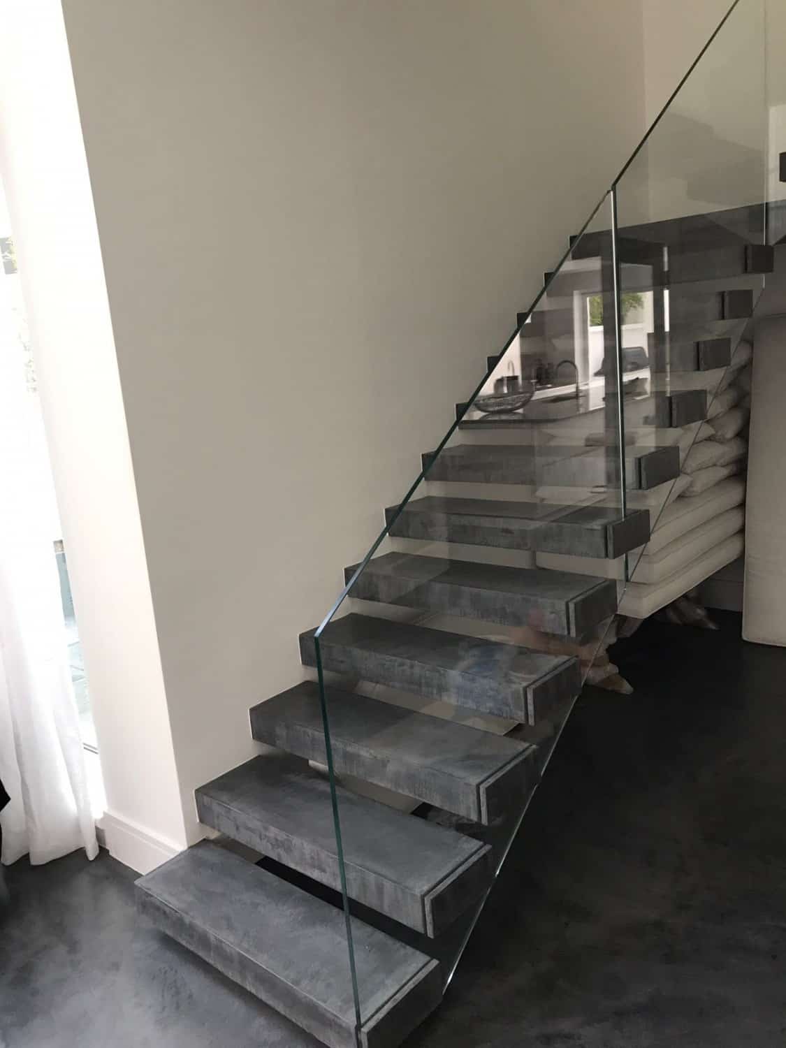 Concrete floor stair case with glass sides