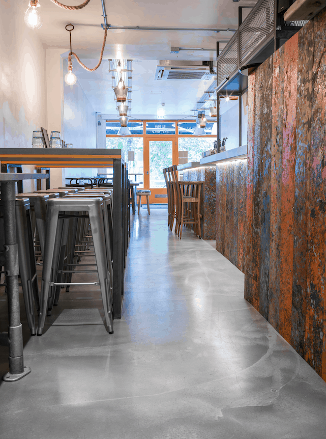 View along the side of a wooden bar in a restaurant