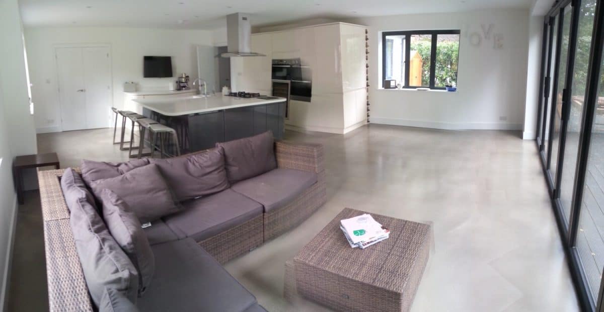 Open plan living room and kitchen with polished concrete floor