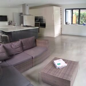 Open plan living room and kitchen with polished concrete floor