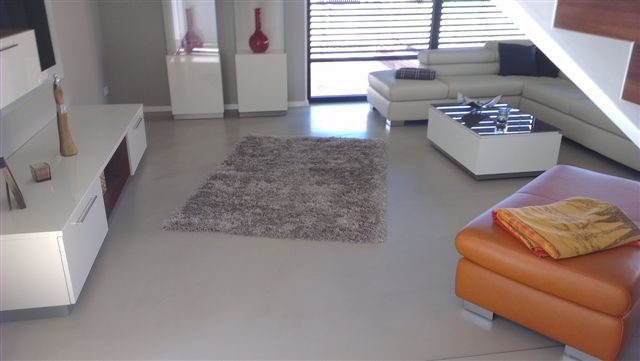polished concrete floors complete a modern interior design living room